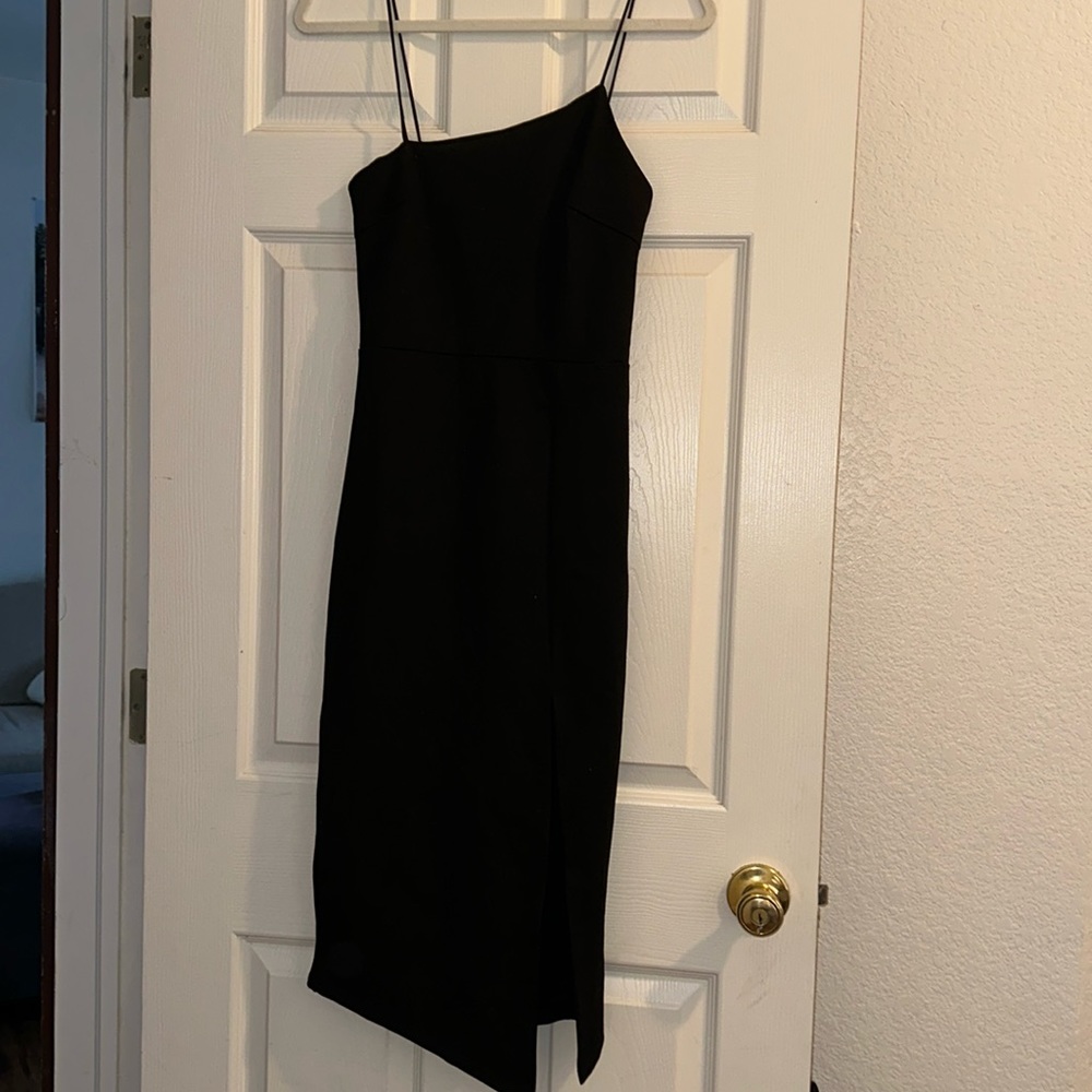 Beginning boutique black asymmetrical dress with slit